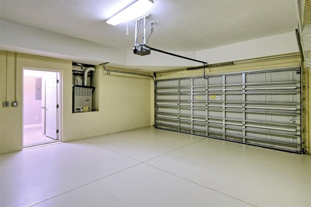 garage with a garage door opener and electric panel