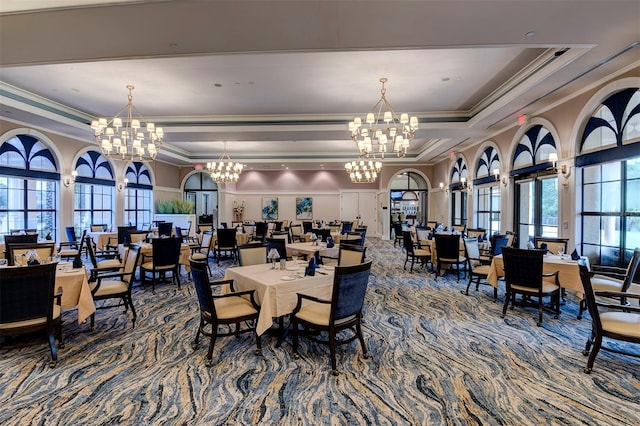 dining room with plenty of natural light, a raised ceiling, and a chandelier