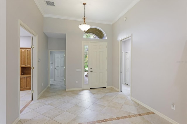 entrance foyer with ornamental molding and light tile patterned floors