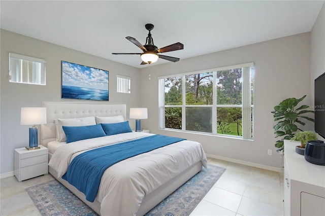 tiled bedroom featuring ceiling fan