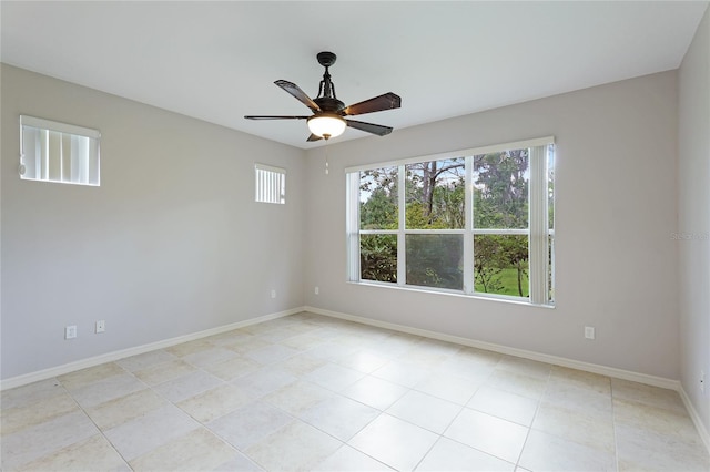 empty room featuring light tile patterned flooring and ceiling fan