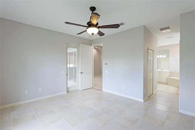 tiled empty room with ceiling fan