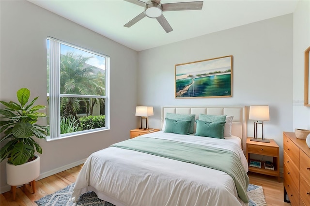 bedroom with light hardwood / wood-style flooring and ceiling fan