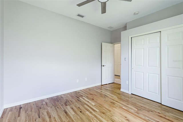 unfurnished bedroom with light hardwood / wood-style flooring, a closet, and ceiling fan