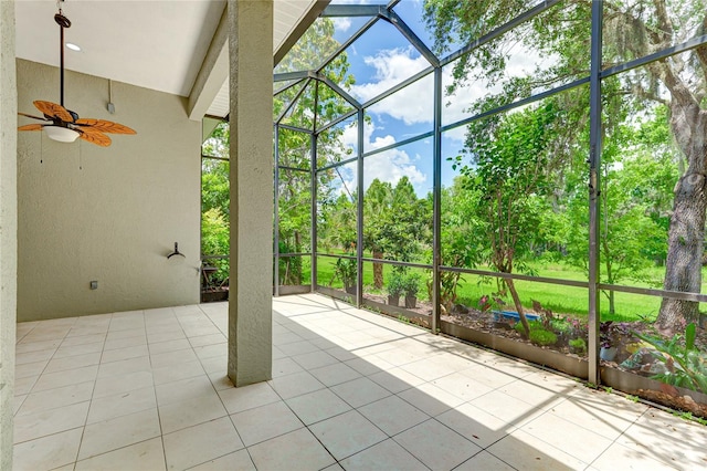 unfurnished sunroom featuring ceiling fan