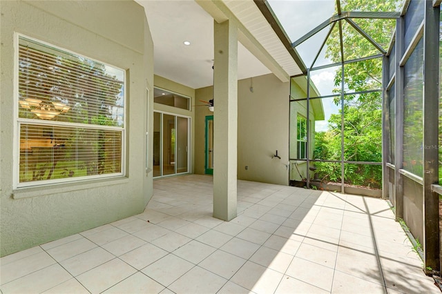 unfurnished sunroom featuring ceiling fan