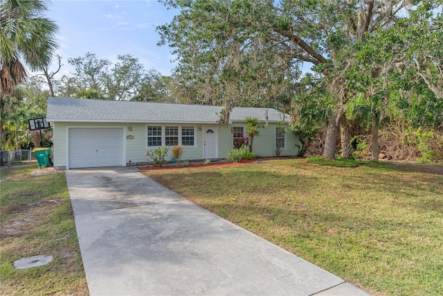 ranch-style home featuring a garage and a front lawn