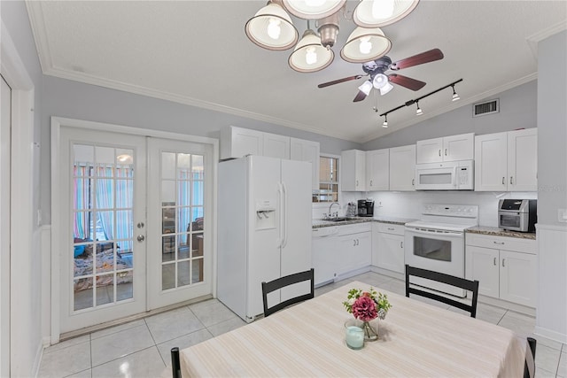 kitchen featuring french doors, white cabinets, tasteful backsplash, white appliances, and lofted ceiling