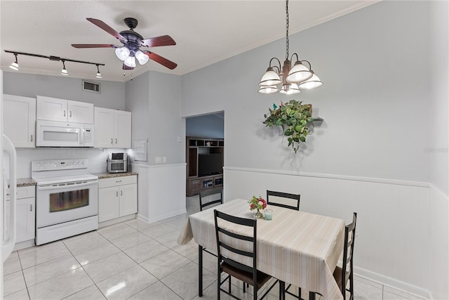 kitchen with white appliances, white cabinetry, light tile patterned floors, and pendant lighting