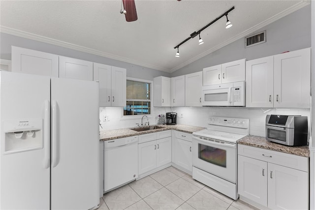 kitchen with sink, white appliances, white cabinetry, and vaulted ceiling