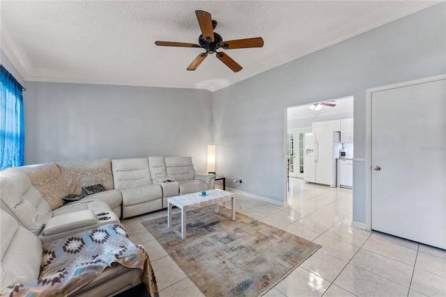 living room featuring ceiling fan, ornamental molding, a textured ceiling, and light tile patterned flooring