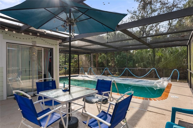 view of pool featuring glass enclosure and a patio area