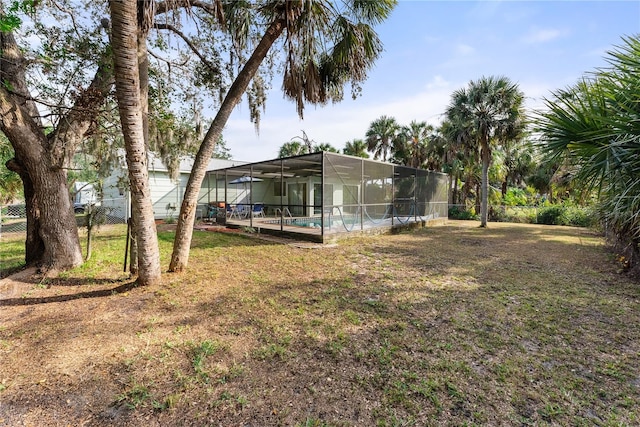 view of yard with glass enclosure