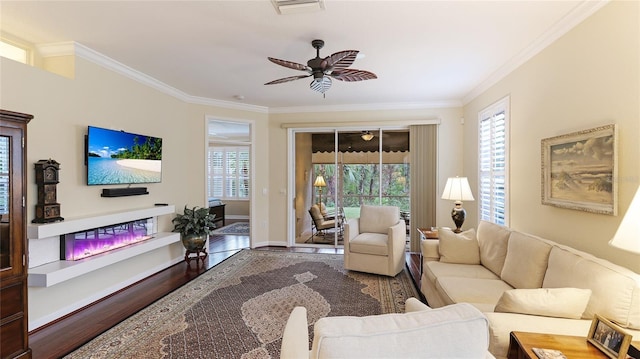 living room with crown molding, wood-type flooring, and ceiling fan