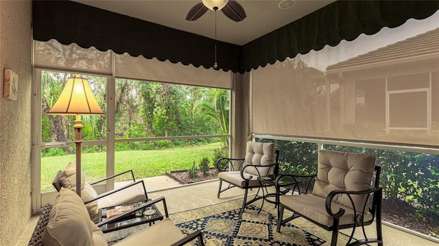 sunroom / solarium featuring ceiling fan