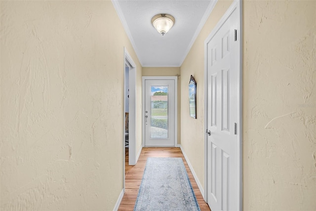 doorway featuring ornamental molding and wood-type flooring