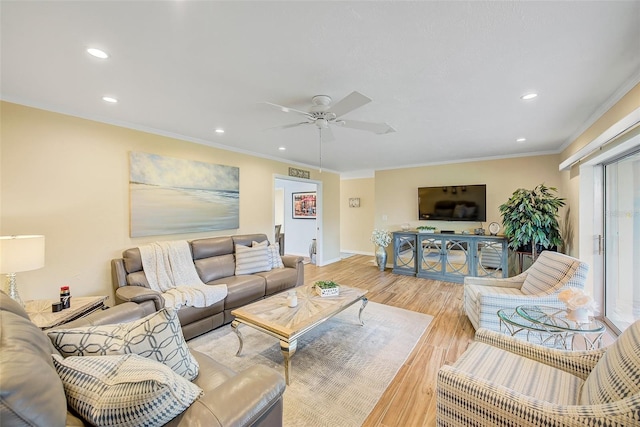 living room with ornamental molding, ceiling fan, and light hardwood / wood-style flooring