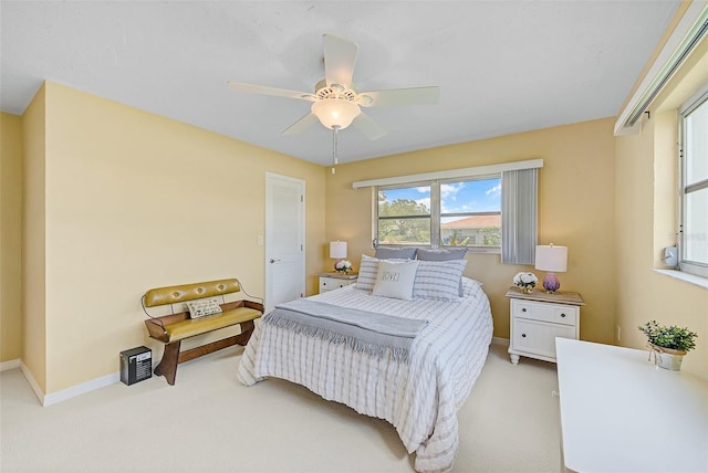 bedroom featuring light carpet and ceiling fan