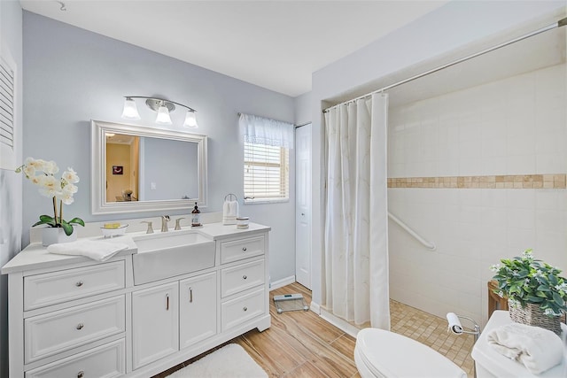 bathroom featuring hardwood / wood-style flooring, vanity, toilet, and a shower with shower curtain