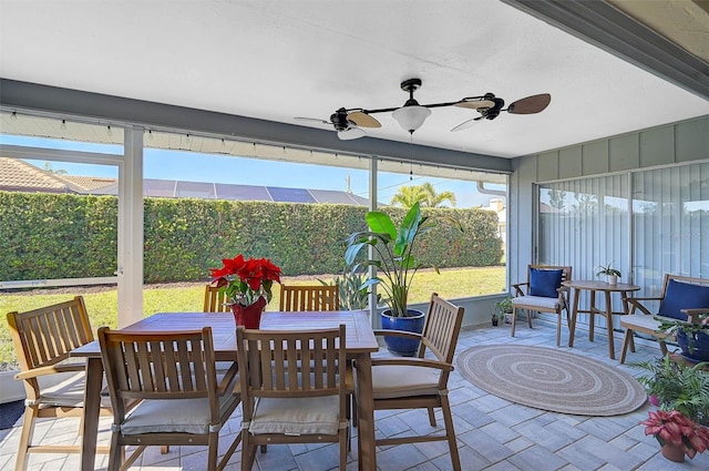 sunroom / solarium featuring ceiling fan