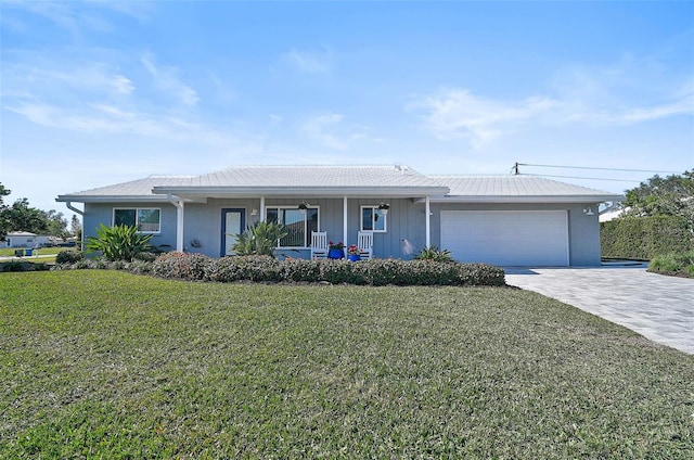 single story home with a garage, a front yard, and a porch