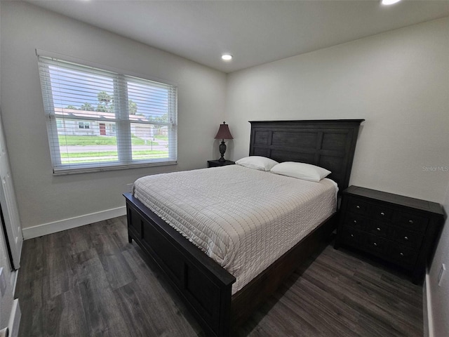 bedroom with dark wood-type flooring