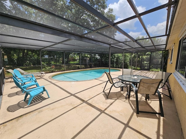 view of pool featuring a patio area and glass enclosure