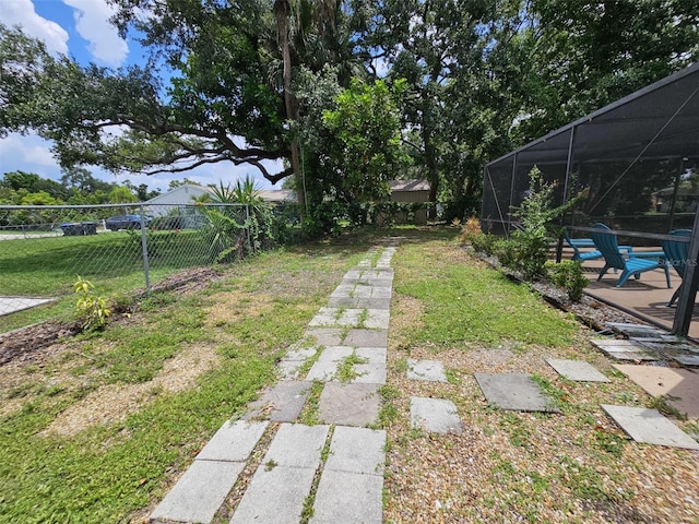 view of yard featuring a lanai and a patio area