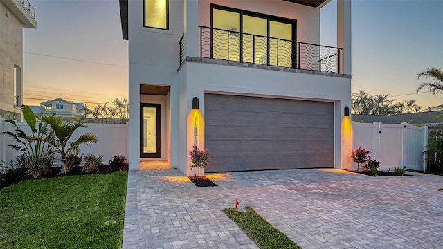 contemporary home featuring a balcony and a garage