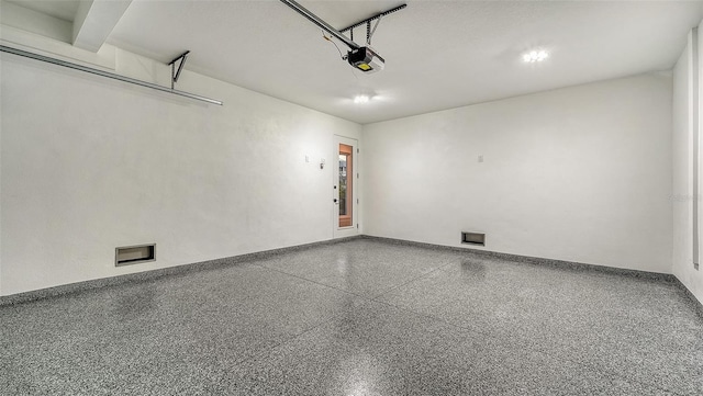 garage with baseboards and a garage door opener