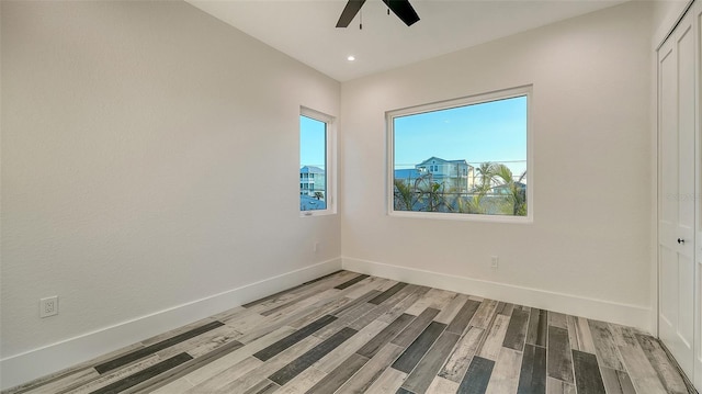 spare room with recessed lighting, ceiling fan, light wood-style flooring, and baseboards