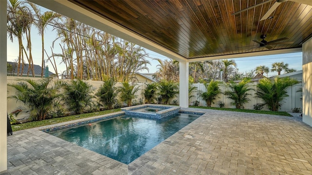 view of swimming pool featuring an in ground hot tub and a patio area