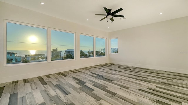 spare room featuring recessed lighting, visible vents, ceiling fan, wood finished floors, and baseboards