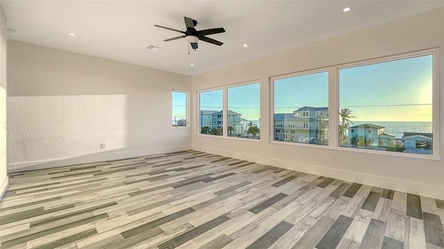 spare room featuring recessed lighting, visible vents, light wood-style floors, ceiling fan, and baseboards