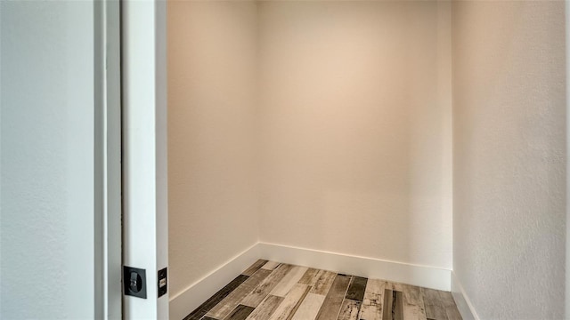 washroom with light wood-style flooring and baseboards