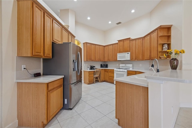 2773 Harvest Dr, Sarasota, FL 34240 - kitchen with a sink, open shelves, a high ceiling, a peninsula, and white appliances