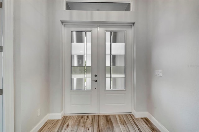 doorway to outside with french doors and light wood-type flooring