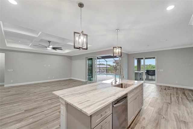 kitchen featuring decorative light fixtures, dishwasher, an island with sink, sink, and light wood-type flooring