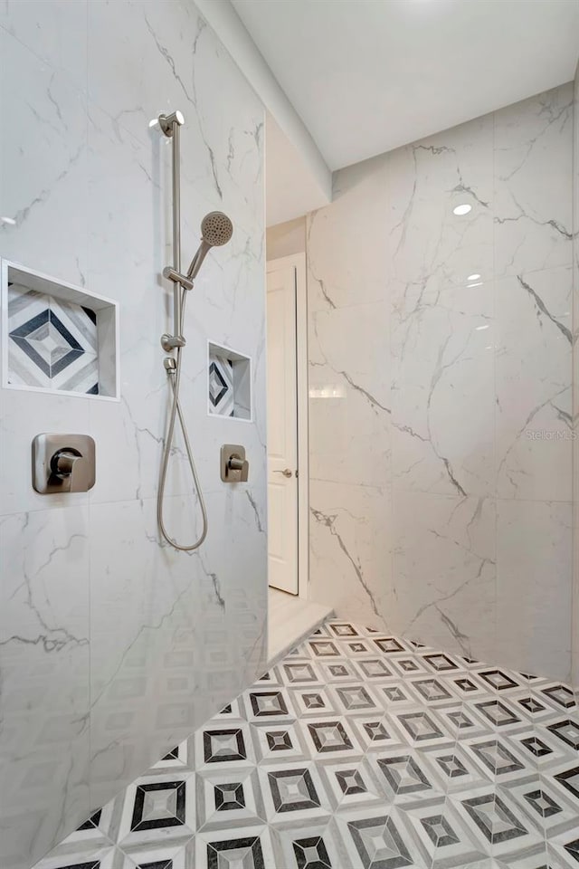 bathroom with a tile shower