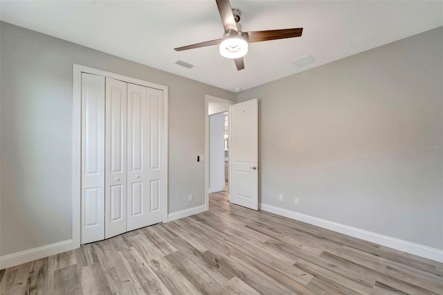 unfurnished bedroom featuring ceiling fan, a closet, and light hardwood / wood-style flooring