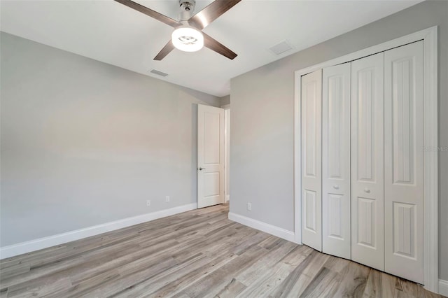 unfurnished bedroom featuring a closet, ceiling fan, and light wood-type flooring