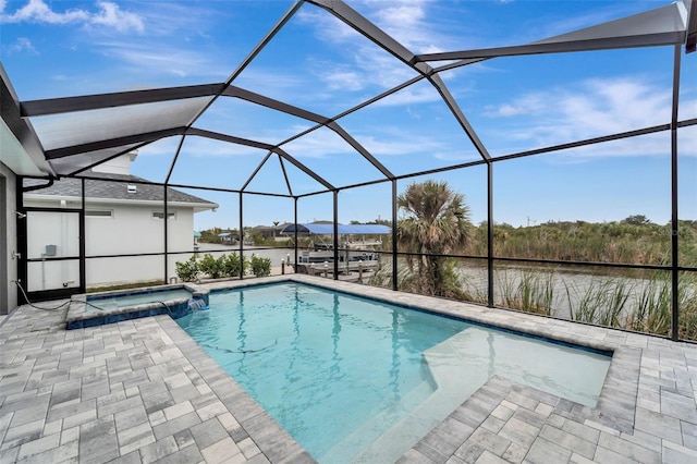 view of pool featuring an in ground hot tub, a water view, a lanai, and a patio