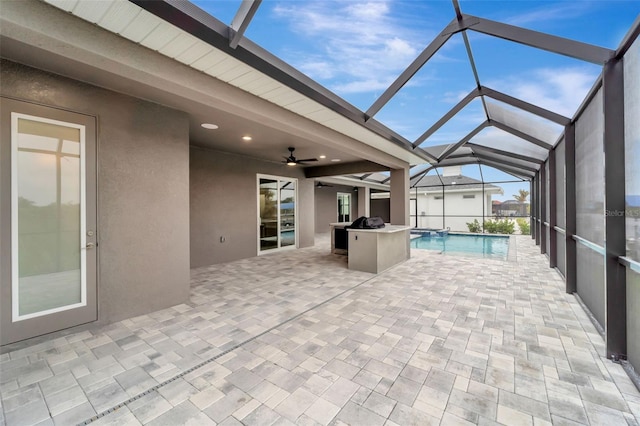 view of pool with a lanai, ceiling fan, and a patio area