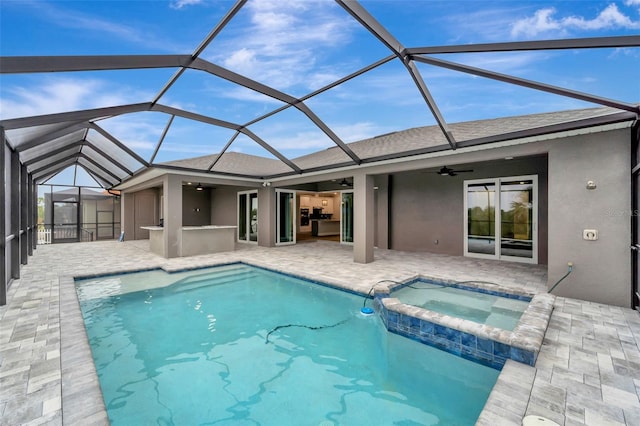 view of swimming pool with an in ground hot tub, a lanai, ceiling fan, and a patio