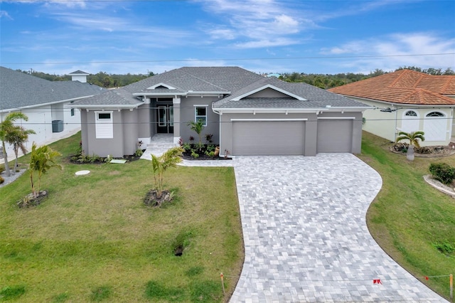 view of front of home with a garage and a front lawn