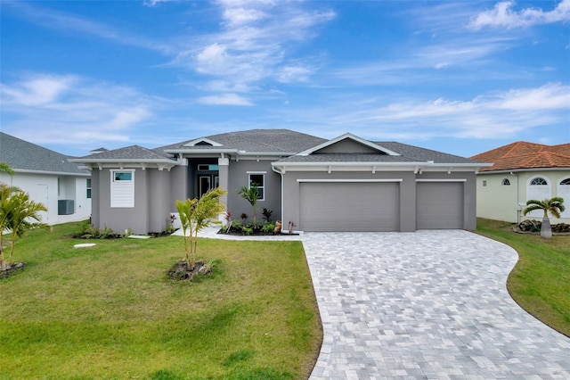 view of front of house featuring a garage and a front lawn