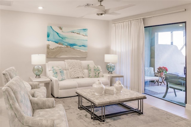 living room featuring tile patterned floors and ceiling fan