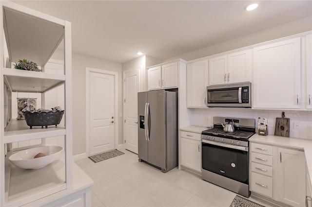 kitchen with white cabinetry, light tile patterned floors, tasteful backsplash, and stainless steel appliances