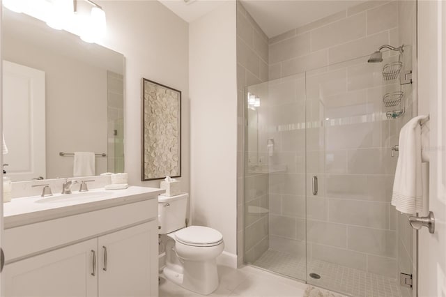 bathroom featuring vanity, tile patterned flooring, a shower with shower door, and toilet