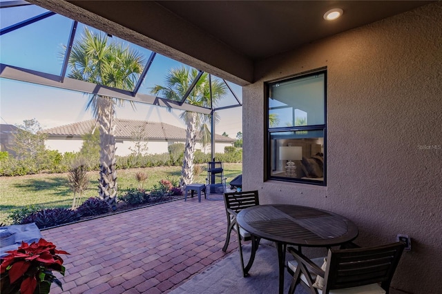 view of patio / terrace featuring glass enclosure